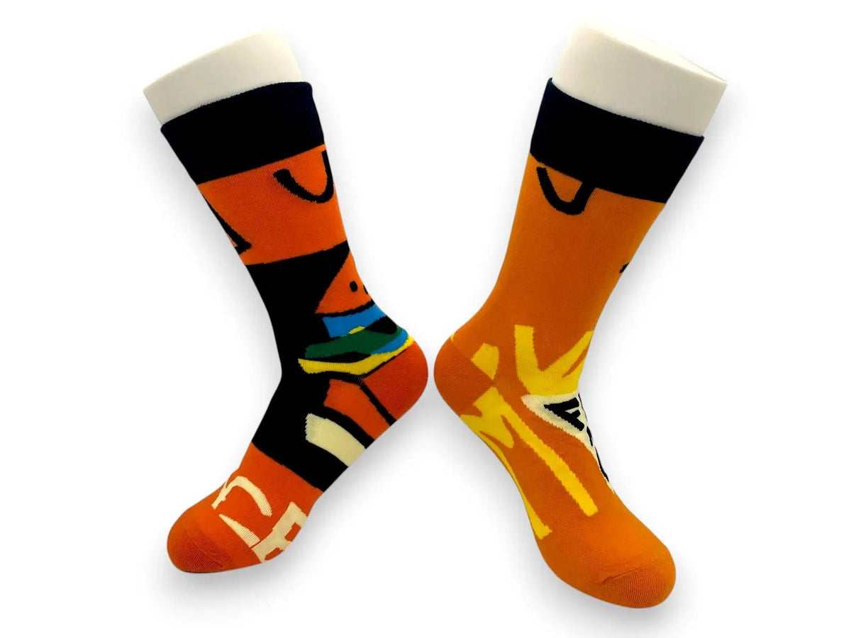 Mismatched orange fish-and-chips socks on foot forms facing outward