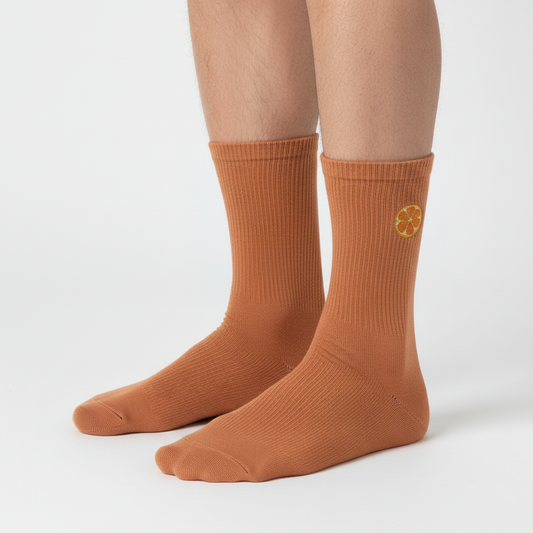 Feet with citrus emblems on outer ankle sides of both socks
